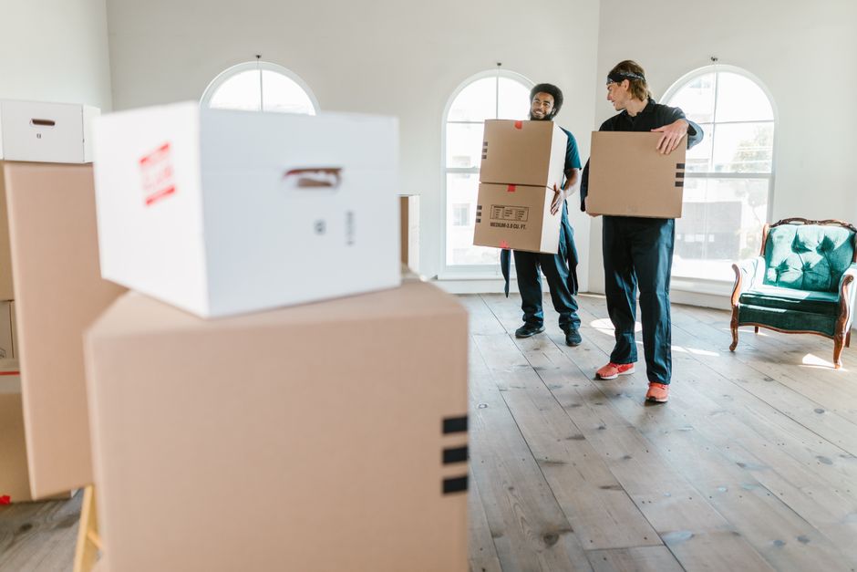 Professional moving team standing by moving truck