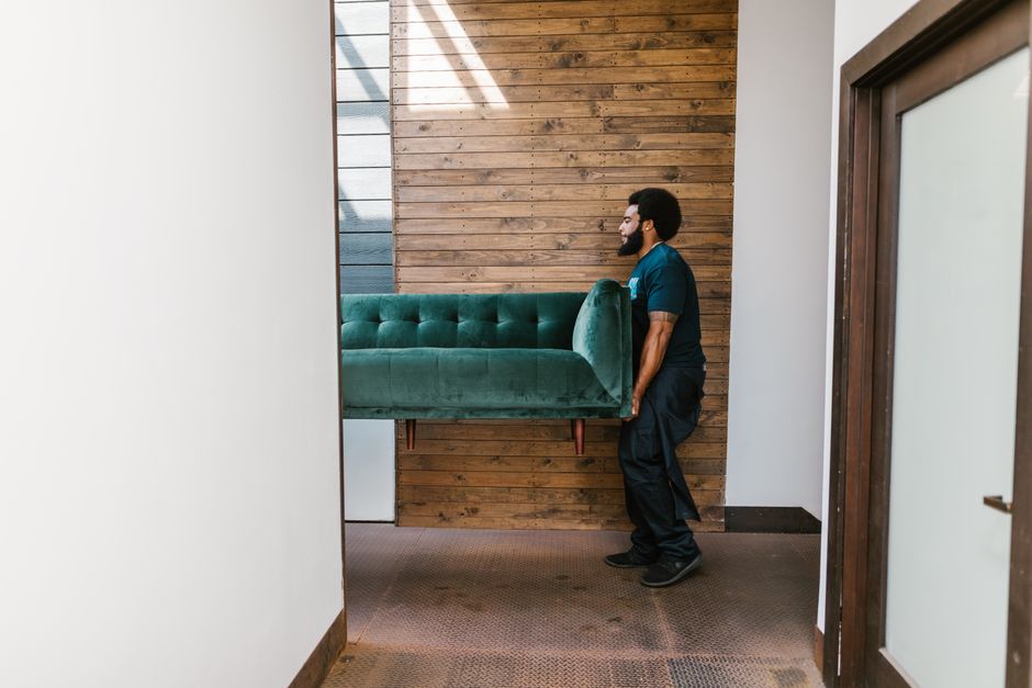 Local movers lifting heavy furniture safely
